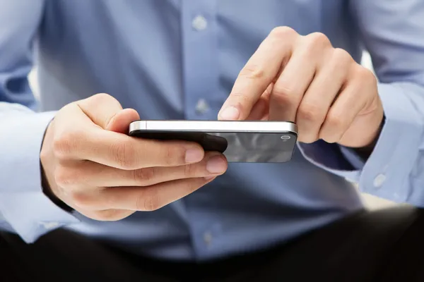 Young adult using a smart phone — Stock Photo, Image
