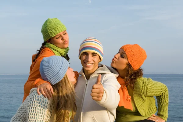 Happy boy surrounded by girls blowing kisses — Stock Photo, Image