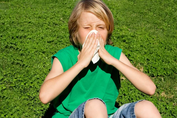 stock image Child with hayfever allergy sneezing into tissue