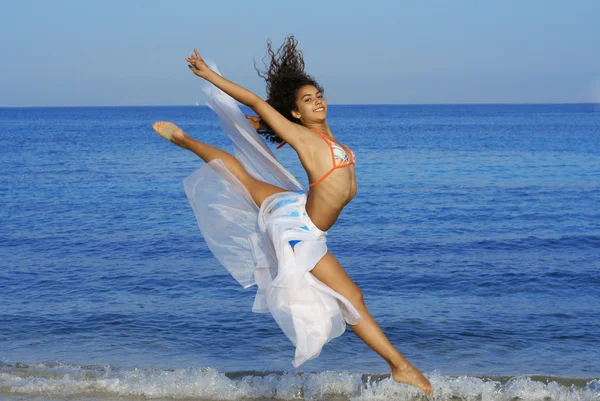 Happy healthy woman leaping on seashore on summer vacation — Stock Photo, Image
