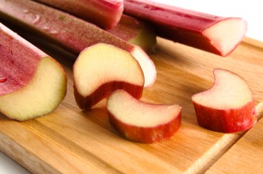 Rhubarb on a kitchen board, it is isolated on white clipart