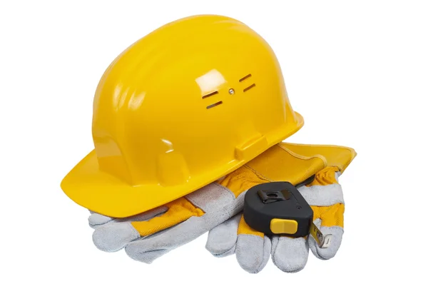 Инструменты и шлем строителя, он изолирован на белом — стоковое фото