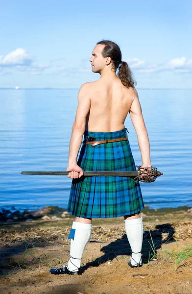 Man with naked torso in kilt — Stock Photo, Image