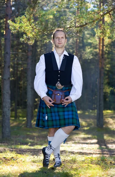 Man in scottish costume in the forest — Stock Photo, Image