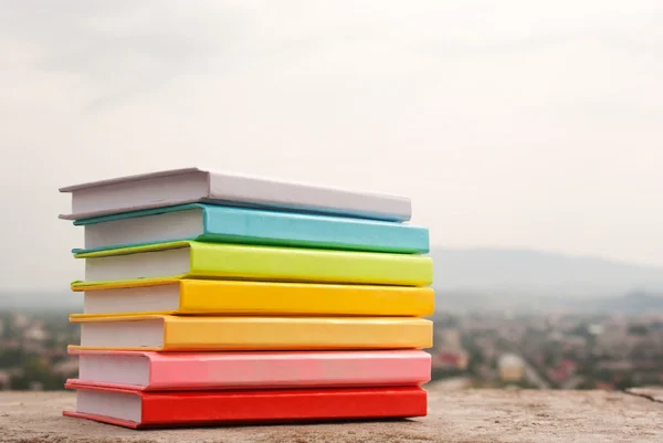 Pila de libros coloridos que ponen al aire libre — Foto de Stock