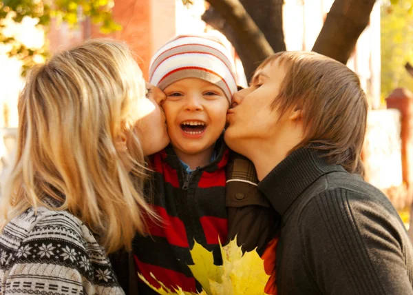 Happy family of three at fall time — Stock Photo, Image