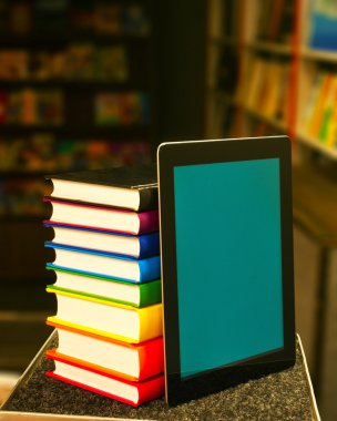 Stack of books with a tablet PC clipart