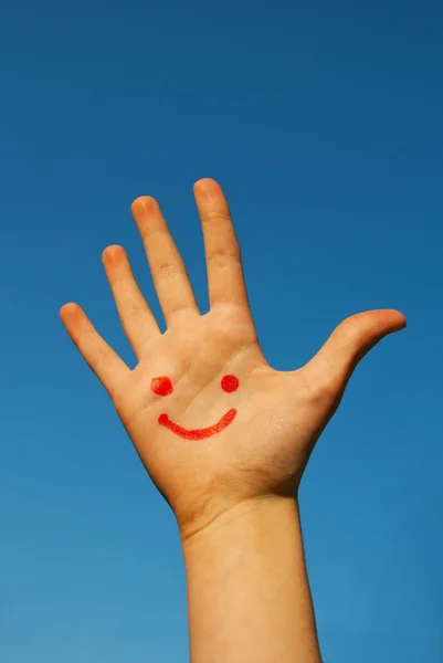 Menschliche Handfläche mit einem Lächeln darauf — Stockfoto