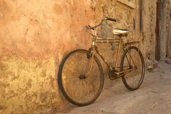 Старый велосипед у стены — стоковое фото