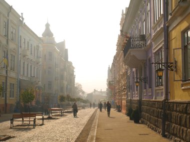 The morning fog on the main street of the Chernivtsi clipart