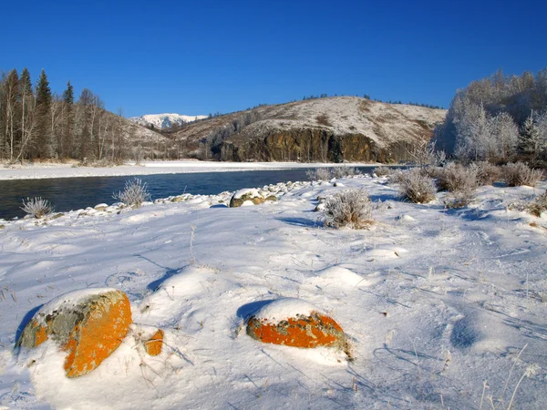 Winter landscape with welloy stones and river in mountains — Stok fotoğraf