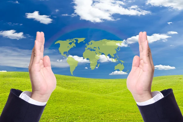 Green world map in business man hand — Stock Photo, Image