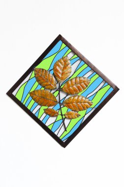 Metal leaves in the sqaure isolate on white wall clipart