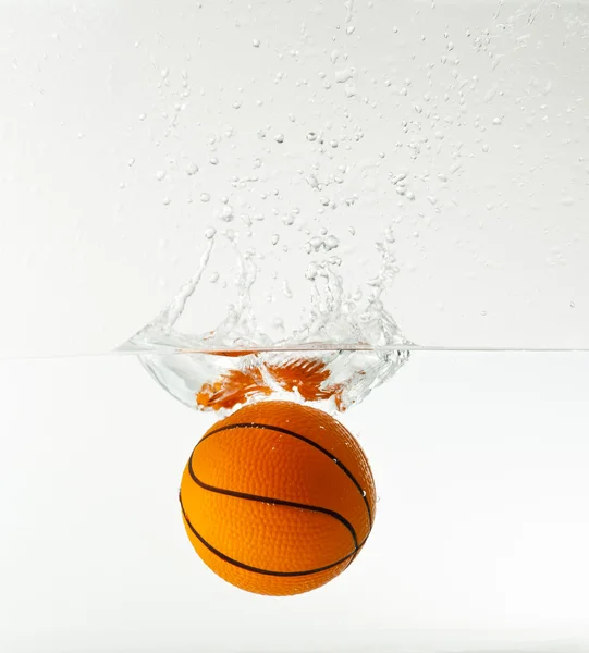 Basketball under water with splash isolated on white background — Stock Photo, Image