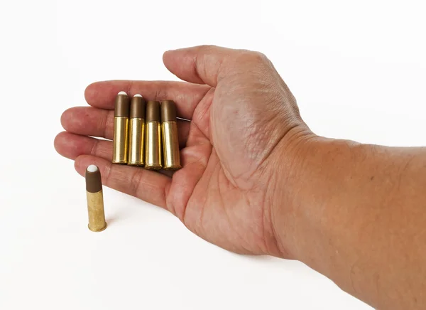 Quatro balas na mão isoladas no fundo branco — Fotografia de Stock