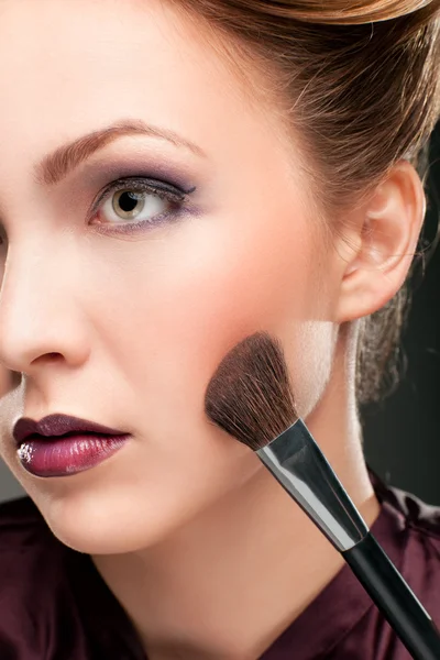 stock image Beautiful woman with makeup brush