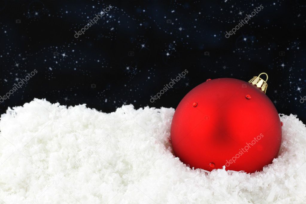 Red Christmas ball on snow