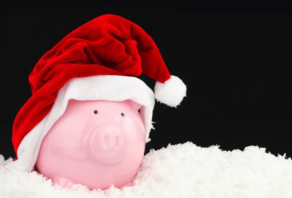 Santa Claus Sparschwein auf Schnee — Stockfoto