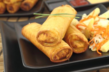 Spring rolls on a plate clipart