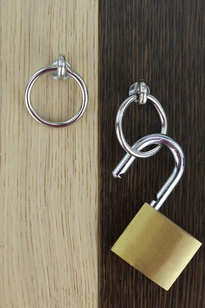 Opened padlock on wooden door — Stock Photo, Image