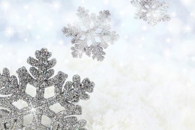 Snowflake on the snow background clipart