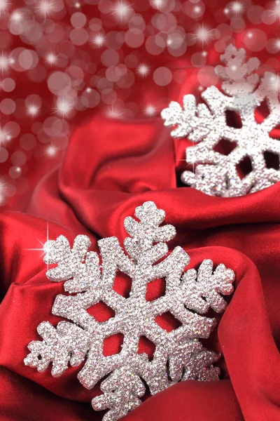 Snowflake on the red satin background — Stock Photo, Image