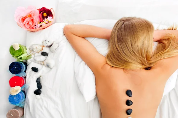 Woman getting recreation massage in spa salon - high angle