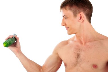 Portrait Of Muscular Young Man holding cucumber and doing exerci clipart