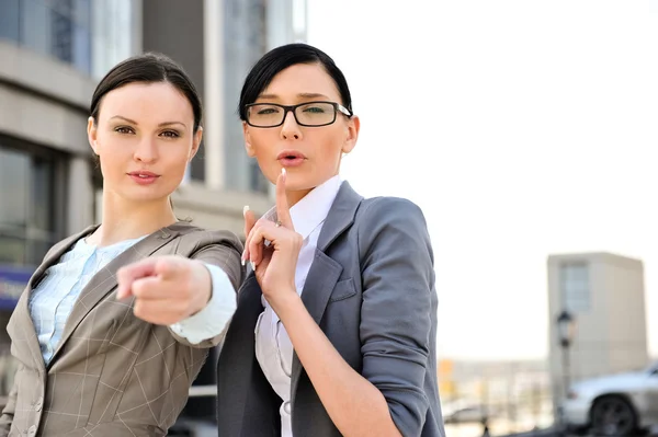 Portrait of a beautiful business woman pointing to camera with a — Stock Photo, Image