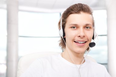 Confident sales representative man with an headset at his workpl clipart