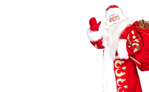 Santa Claus de pie sobre fondo blanco con su bolsa llena de —  Fotos de Stock