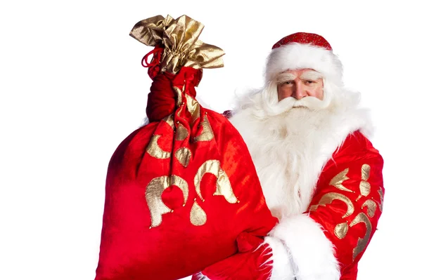 Santa claus opstaan op witte achtergrond met zijn zak vol — Stockfoto