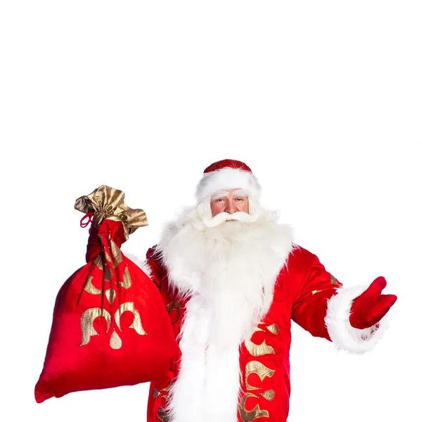 Papai Noel de pé no fundo branco com sua bolsa cheia de — Fotografia de Stock