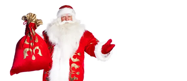 Babbo Natale in piedi su sfondo bianco con la sua borsa piena di — Foto Stock