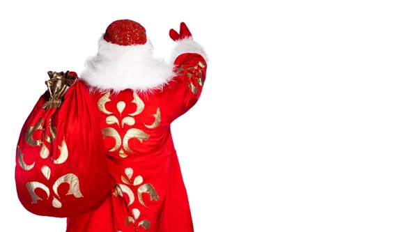 Santa Claus de pie sobre fondo blanco con su bolsa llena de — Foto de Stock