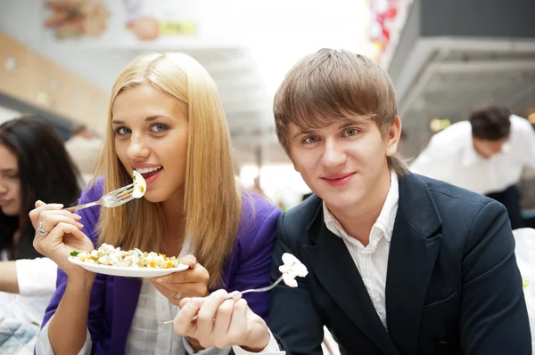 Closeup portrait of an attractive young couple eating fruit sala — Stock Photo, Image