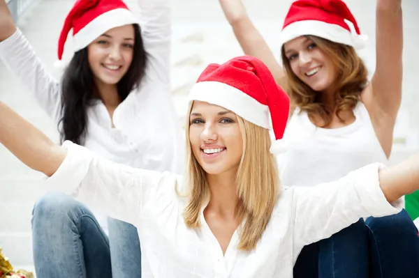 Group of three happy pretty girls are celebrating christmas and — Stock Photo, Image
