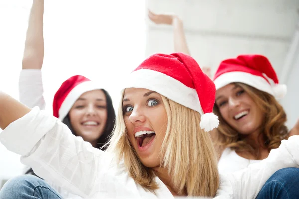 Group of three happy pretty girls are celebrating christmas and Royalty Free Stock Photos