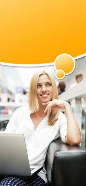 Portrait of happy blond woman using laptop at shopping mall cafe clipart