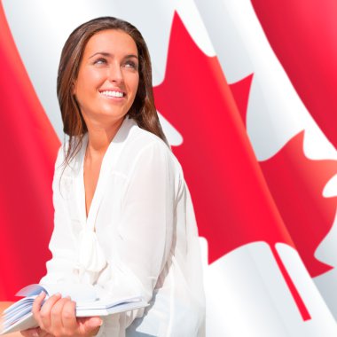 Portrait of pretty young woman holding book in her arms. Canadia clipart