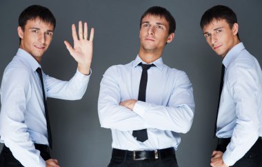 Closeup of a young smiling business man standing in three differ clipart