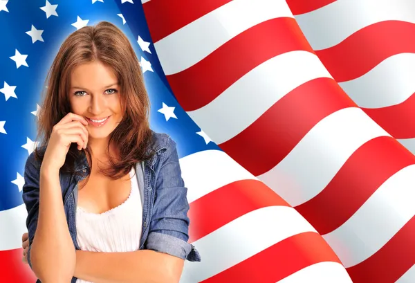 Portrait of a pretty young woman ôïôøòûå an American flag , smil