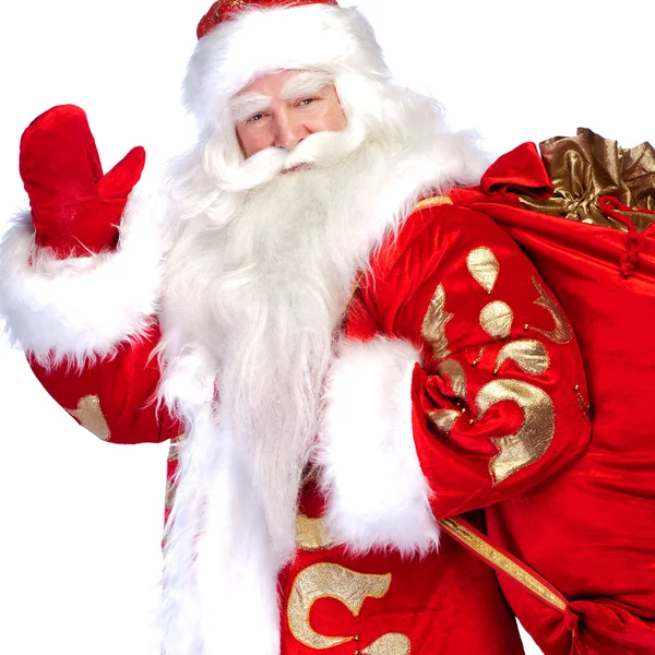 Papai Noel de pé no fundo branco com sua bolsa cheia de — Fotografia de Stock