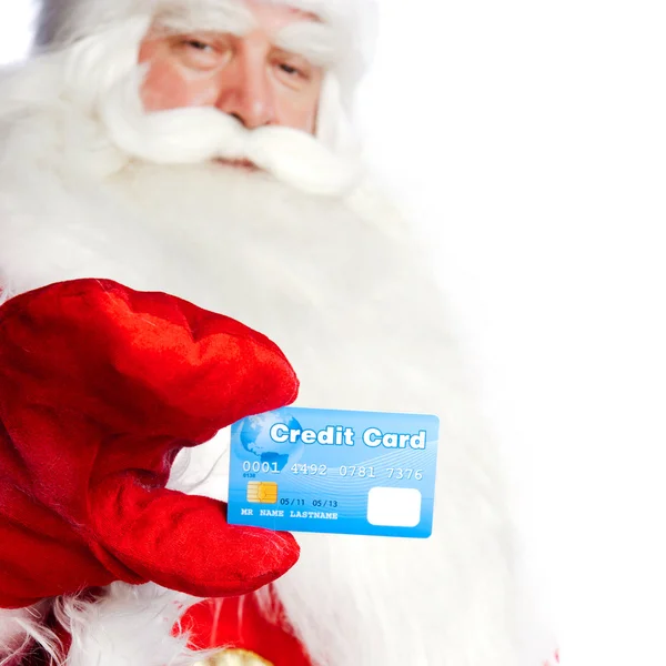 stock image Traditional Santa Claus holding and sowing credit card while giv