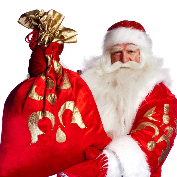 Jultomten står upp på vit bakgrund med hans väska full med — Stockfoto