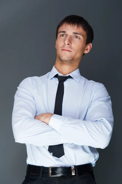 Closeup of a young smiling business man standing confidently aga — Stock Photo, Image