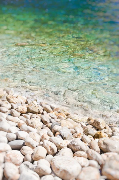 stock image Soft wave of the sea on the pabble-stone beach