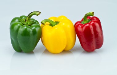 Green, yellow and red capsicums clipart