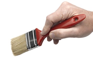 A man's hand holding a paintbrush. (focus on paintbrush) clipart
