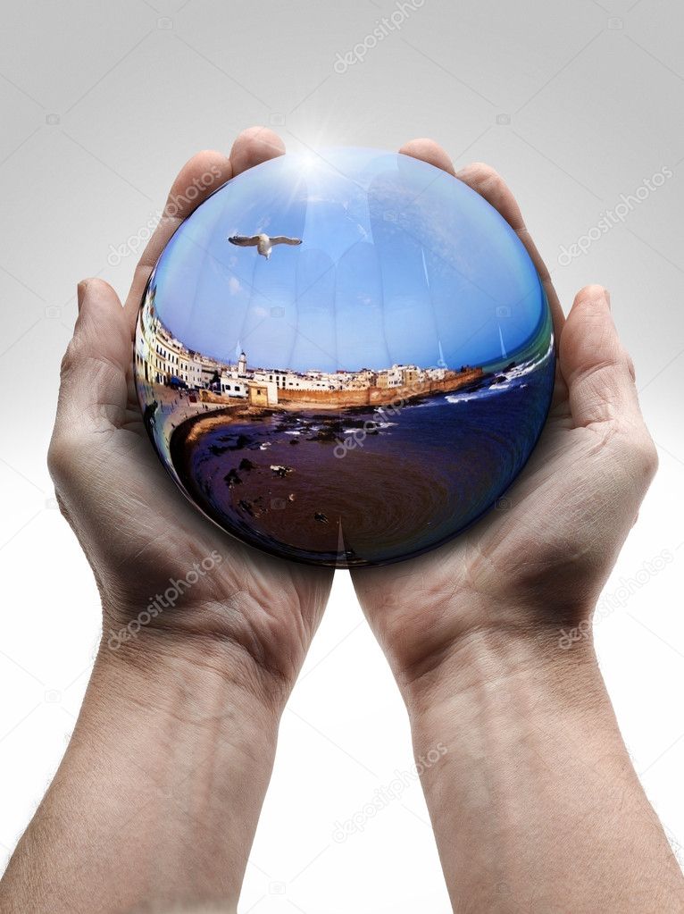 Male hand holding a crystal ball